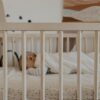 a person sleeping in a crib