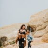 man and woman standing on brown rock formation during daytime