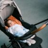 a baby is sleeping in a stroller
