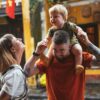 a man holding a young boy on his shoulders